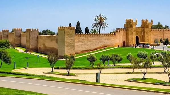 The Chellah necropolis in Rabat — the walled Marinid royal cemetery built over the ruins of the Roman city of Sala Colonia, its minaret rising above fig trees and storks' nests in a setting that layers Roman, Islamic and natural history into one of the most romantically atmospheric sites in Morocco