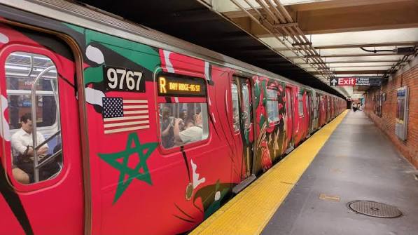 Football supporters travel through a busy public-transportation hub on match day.