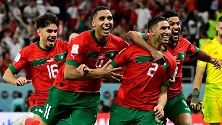 Morocco's players sprint in celebration after the historic 2022 World Cup penalty victory — the moment that announced Africa's new football force