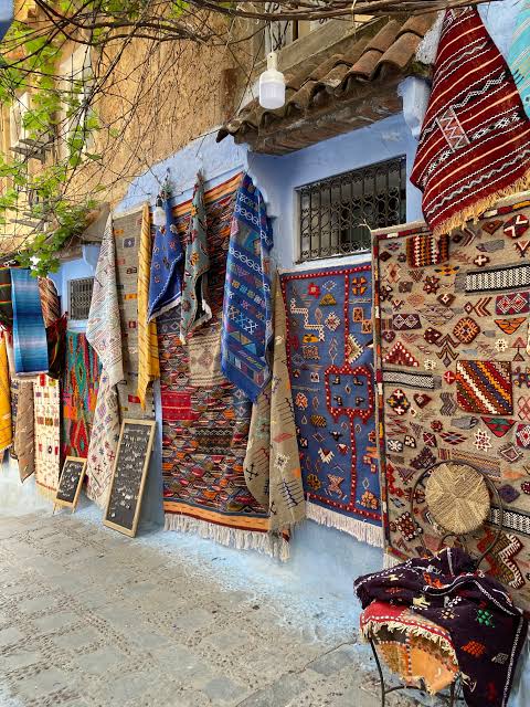 Handwoven textiles and handicrafts displayed in the Chefchaouen medina