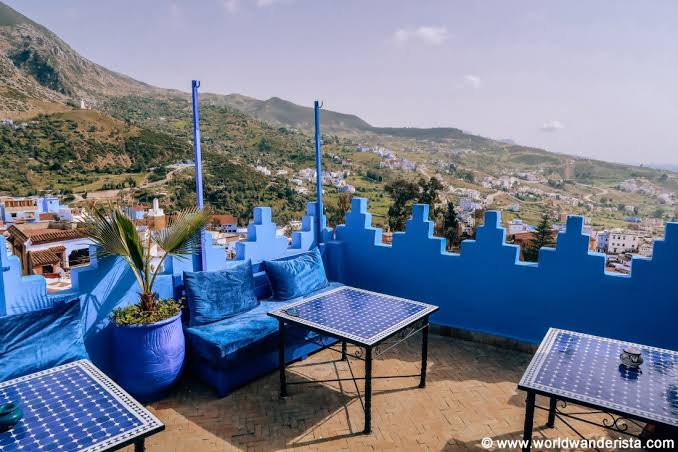 A rooftop café terrace in Chefchaouen overlooking the blue medina rooftops