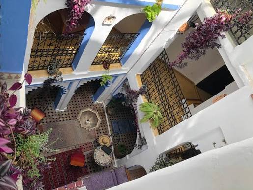 A traditional riad guesthouse interior in Chefchaouen's medina