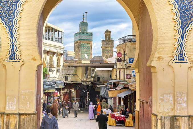 Narrow ochre alleyway in Fes el-Bali medina with traditional architecture