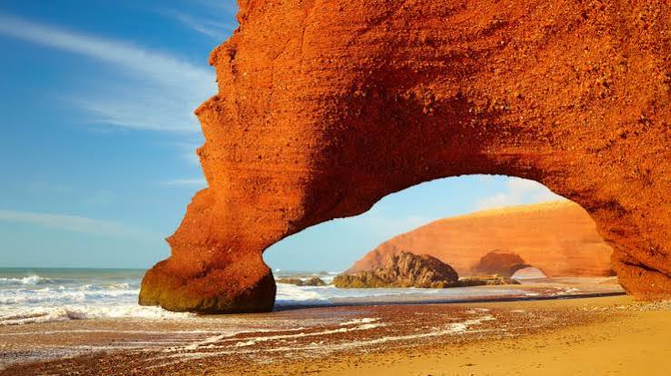 Legzira Beach natural rock arch — dramatic Atlantic cliffs south of Sidi Ifni