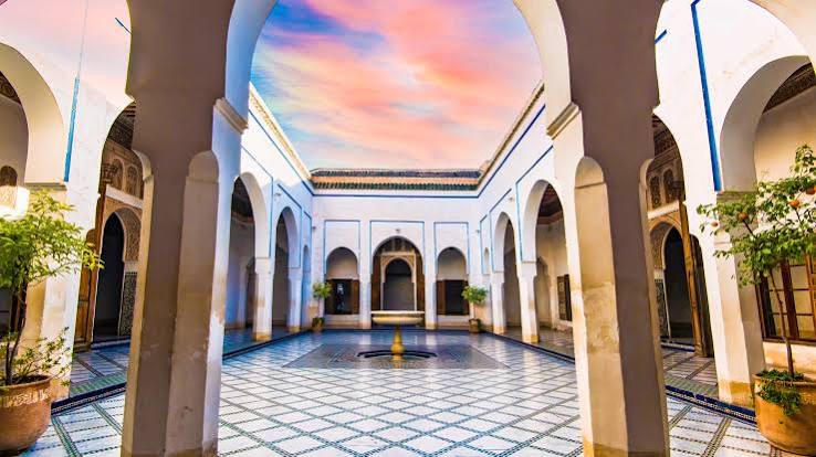 Ornate interior courtyard of Bahia Palace, Marrakech — zellige tilework and carved plaster