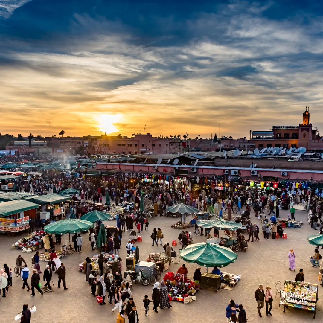 Jemaa el-Fna square at dusk, Marrakech — food stalls, smoke, and the Koutoubia minaret in the background