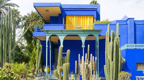 Majorelle Garden Marrakech — cobalt blue studio building surrounded by tropical plants and cactus