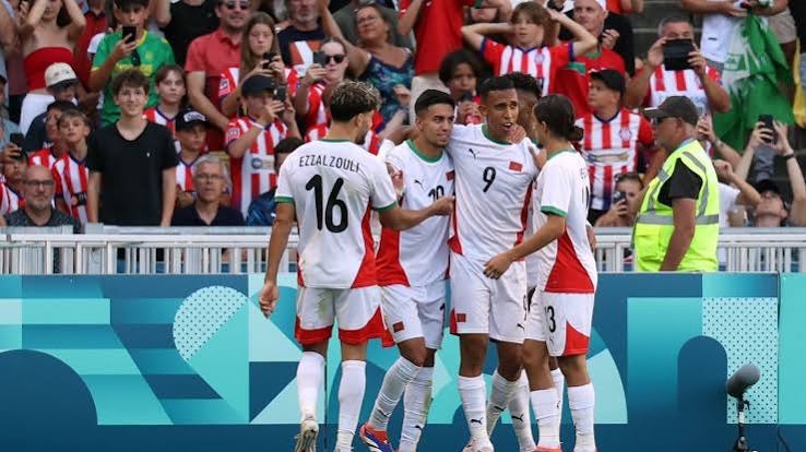 Morocco's players celebrate together after their 6–0 Olympic bronze medal victory over Egypt at Paris 2024 — the country's first Olympic football medal