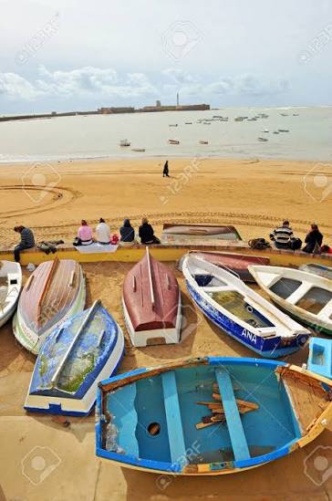 Traditional fishing boats at Oualidia Lagoon — oyster culture and small-scale fishing define the town's identity