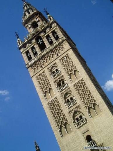 The Giralda tower in Seville, with brick lattice panels on its shaft and a later belfry at the top