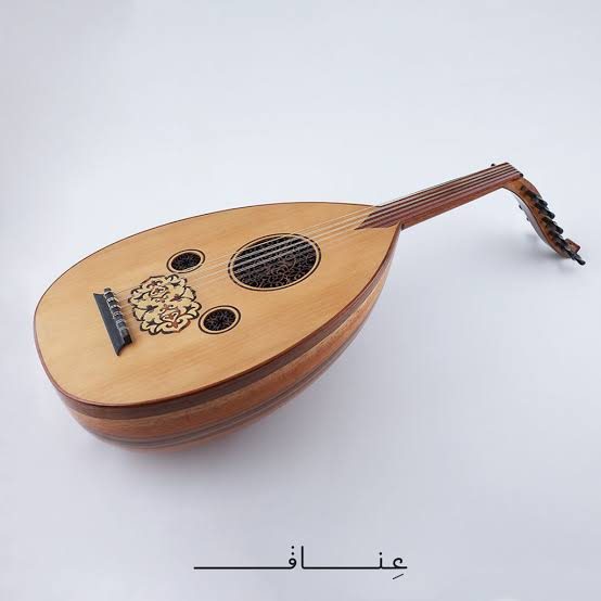 A wooden oud with a rounded body, carved rosettes and a bent-back pegbox