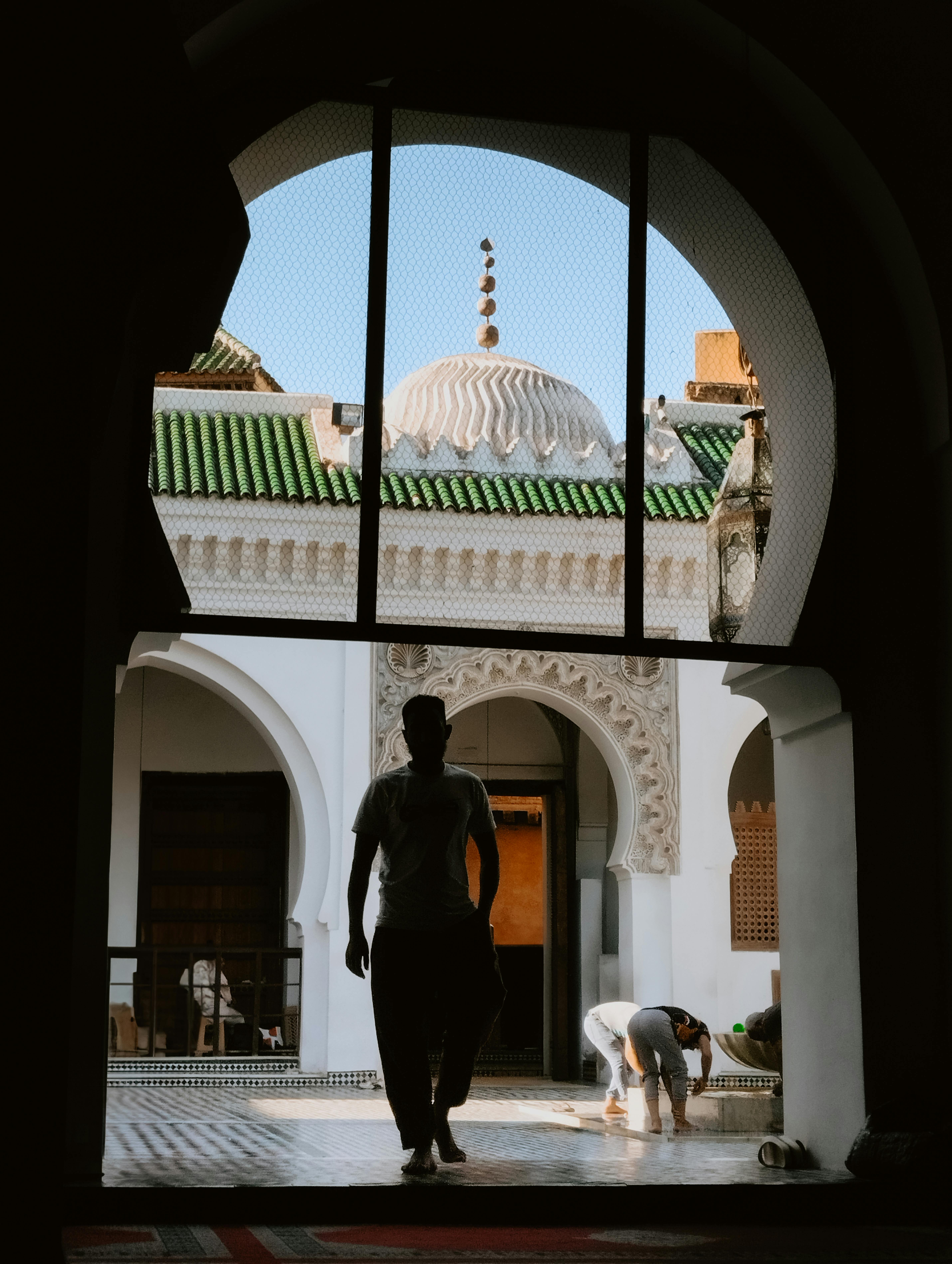Al-Qarawiyyin mosque courtyard seen through a Moorish archway