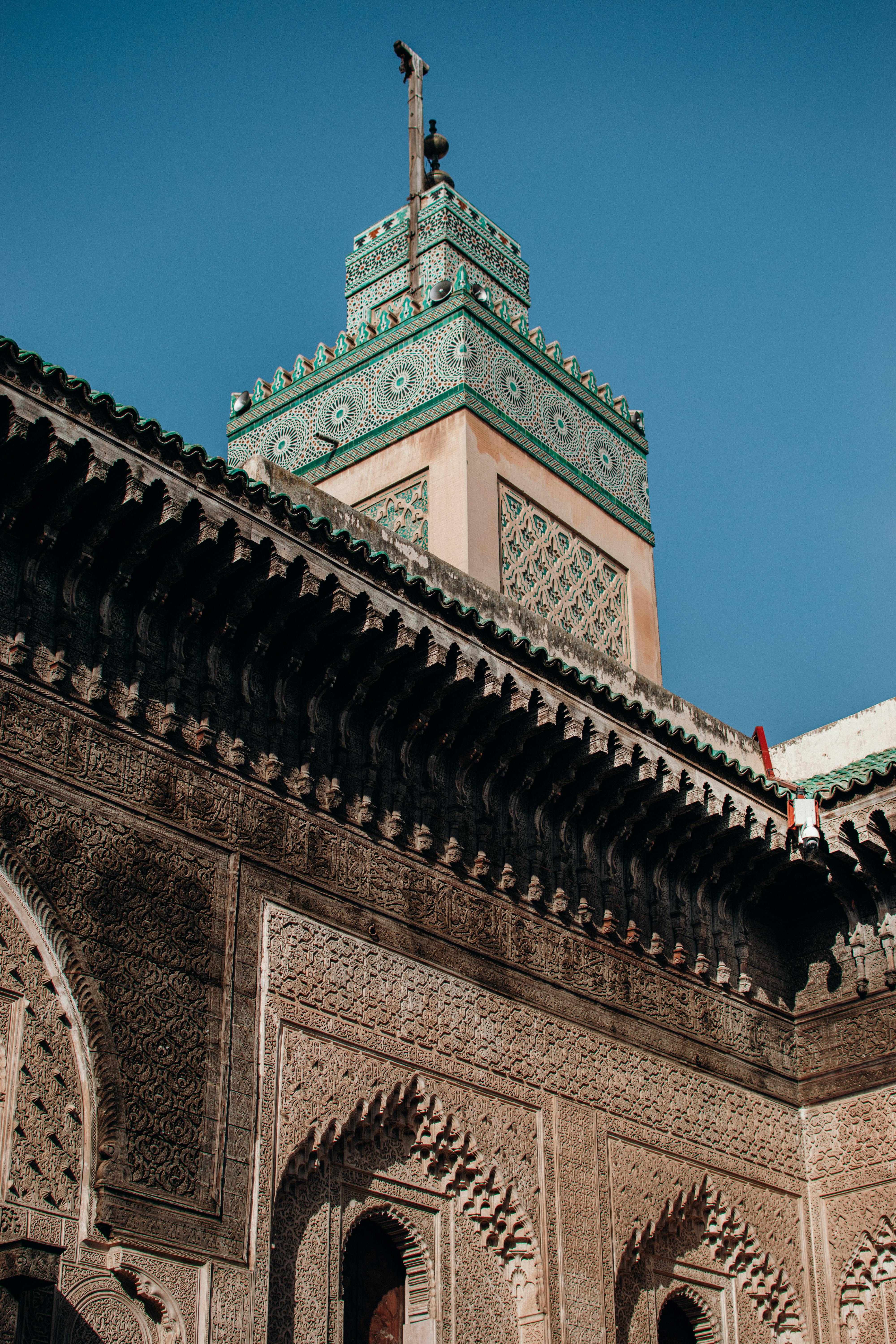 Intricate carved façade and minaret of a Fes madrasa